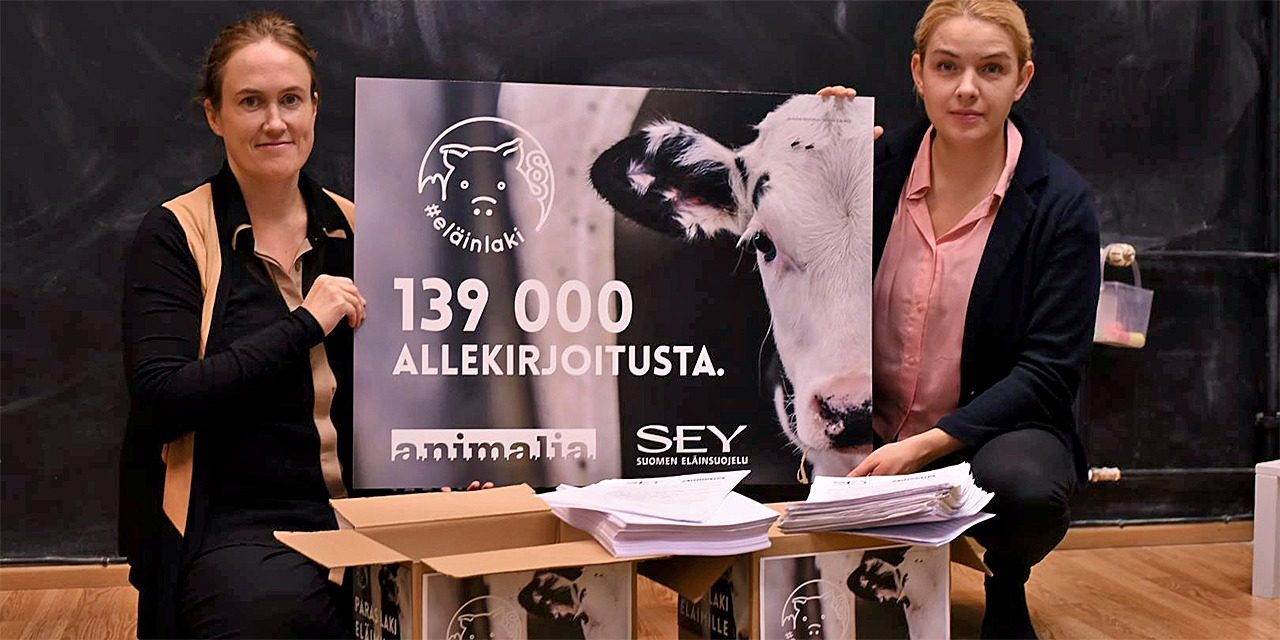 Kati Pulli from Animal Welfare Finland and Mai Kivelä from Animalia holding a "Better Animal Welfare legislation" sign.